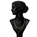 A black mannequin bust wearing a delicate gold-toned chain necklace, 