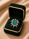 Imperial Emerald Halo Diamond Ring in 18K white gold with a natural emerald and natural diamonds displayed in Izzari's luxury jewellery box