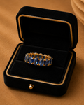 Midnight Sapphire Crown Ring in 18K yellow gold with natural blue sapphires and natural diamonds displayed in a luxury jewellery box