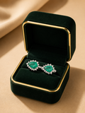Twin Emerald Bloom Diamond Ring in 18K white gold with natural emeralds and natural diamonds displayed in Izzari's luxury jewellery box